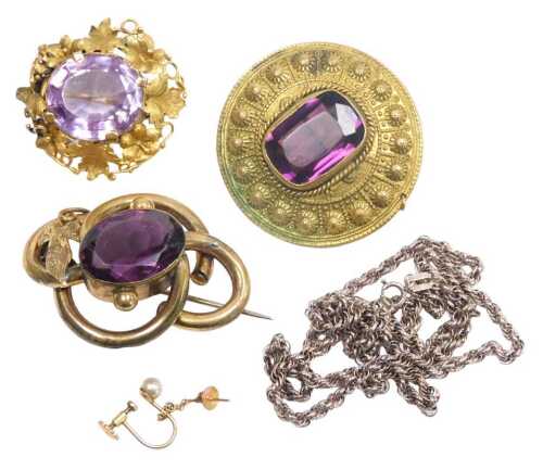 A Victorian amethyst brooch, set in yellow metal, in a floral and foliate design, together with...