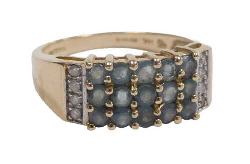A 14ct gold emerald and diamond ring, set with three rows of five brilliant cut emeralds, four...