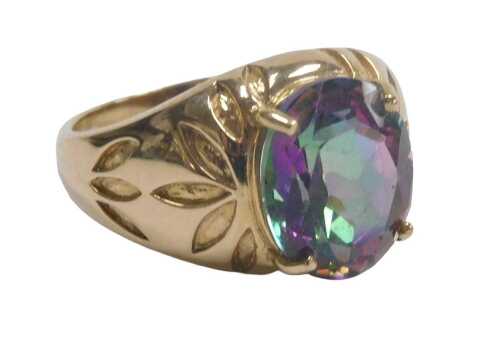 A 9ct gold and morganite solitaire ring, the oval cut stone in a claw setting, with foliate...
