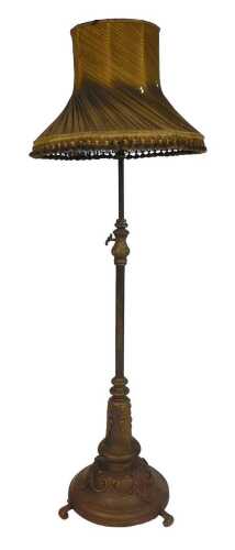 A late 19th/early 20thC adjustable brass floor lamp, with wrought metal leaf mounted cradle,...