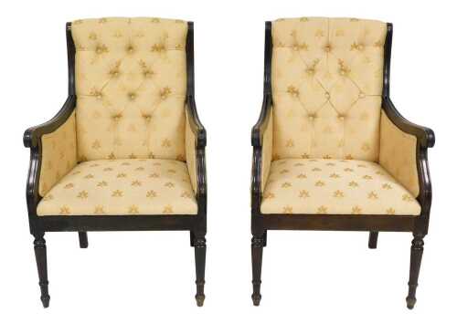 A pair of late 19th/early 20thC Continental ebonised armchairs, each with gold coloured buttoned...