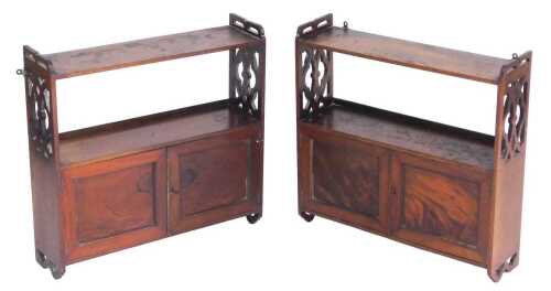 A near pair of Edwardian mahogany wall shelves, each with a shelf, pierced sides and two...