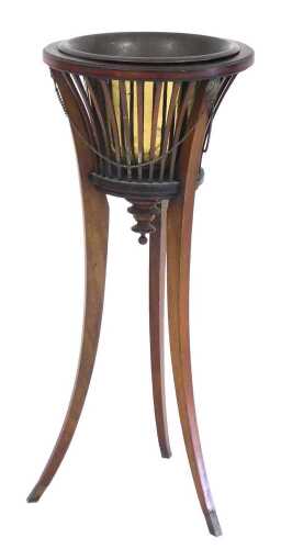 An Edwardian mahogany jardiniere, with a brass liner, tapering slatted sides, joined by a brass...