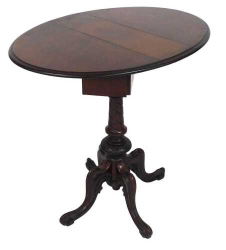A Victorian walnut drop leaf occasional table, the circular top with a moulded edge, above a...