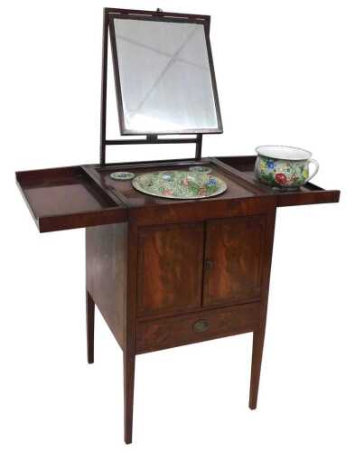An early 19thC figured mahogany enclosed wash stand, the double hinged lid enclosing a recess,...