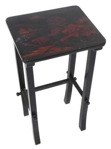 An Oriental black lacquer occasional table, the rectangular top decorated with a landscape, on...