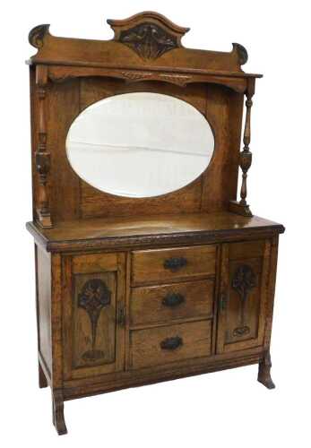 A late 19th/early 20thC oak sideboard, the raised back with a shaped cornice, above an oval...