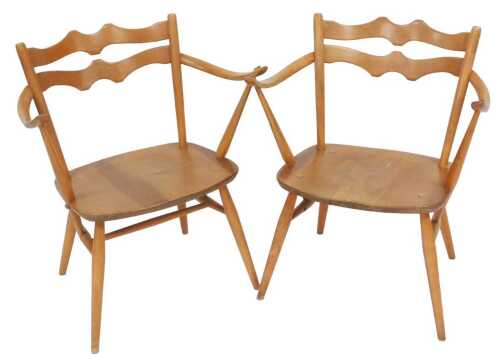 A pair of pale Ercol open armchairs, each with a pierced shaped double ladder back, solid seat,...