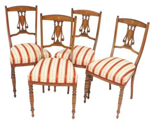 A set of four late Victorian rosewood and marquetry salon chairs, each with a pierced back,...