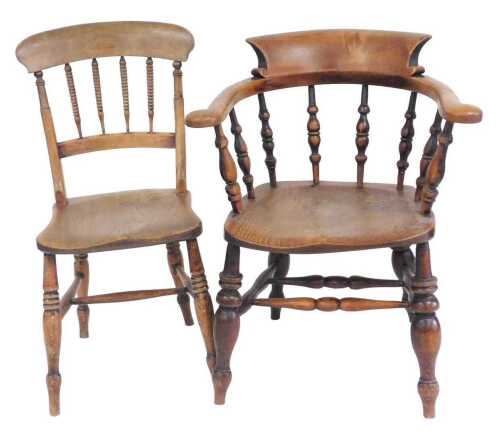 A 19thC ash and elm captain's chair, with a spindle turned back, solid seat, on turned legs with...