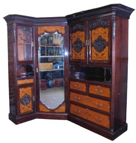 A Victorian mahogany and satinwood corner compactum wardrobe, with floral marquetry inlay, and...