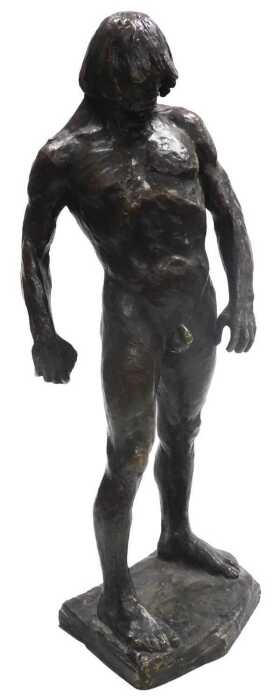 A late 20thC bronze figure of a nude Neanderthal man, modelled in standing pose, holding a...