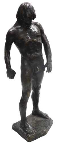 A late 20thC bronze figure of a nude Neanderthal man, modelled in standing pose, holding a...