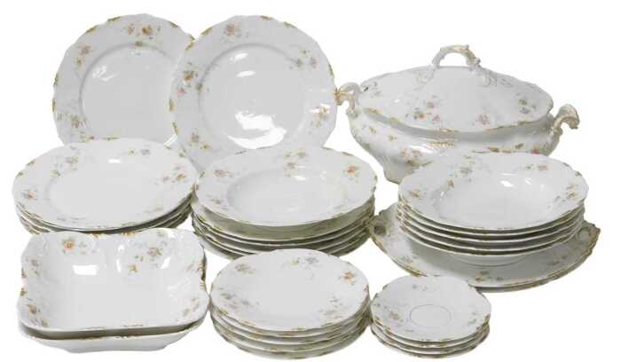 A late 19thC Continental porcelain part dinner service, possibly Limoges, decorated with floral...