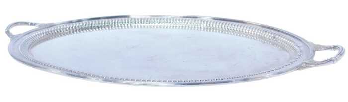 An Edward VII silver twin-handled tray, of oval form, with leaf decoration to each handle, and...