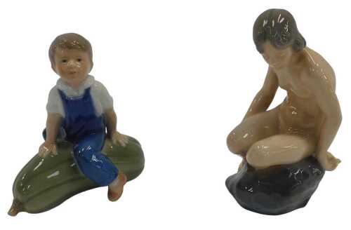 Two Royal Copenhagen porcelain figures, one modelled as a nude female seated on a rock, 14cm...