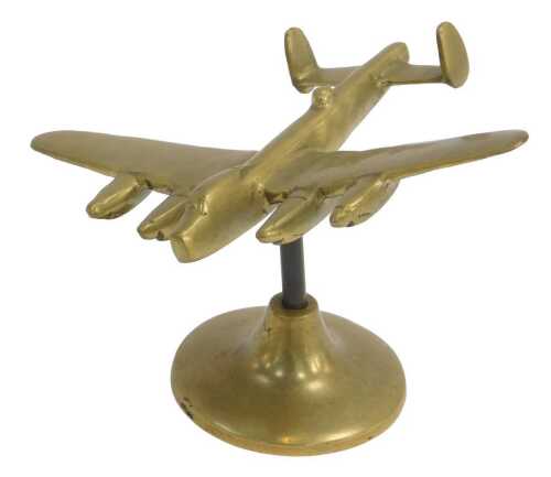 A brass model of a Lancaster, mounted on a circular base, 14cm high. From the collection of...