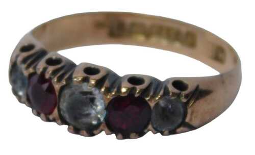 A 9ct gold five stone dress ring, set with two garnets and three imitation diamonds, on a rose...