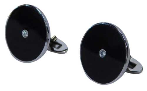 A pair of 9ct white gold enamel and diamond set cufflinks, each formed as a disc with green...