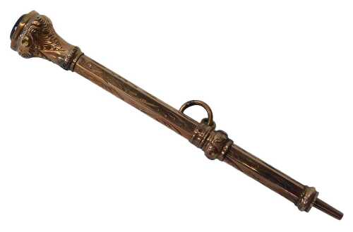 A 19thC propelling pencil case, the top set with a garnet, on a scroll design, yellow metal,...