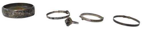 A collection of jewellery, comprising four silver bracelets, comprising two adjustable bracelets...