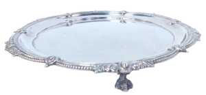 A George V silver salver, with a beadwork border interspersed with flower heads, scrolling and...