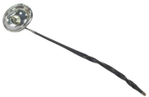 A George III silver toddy ladle, the bowl inset with a 1787 shilling, with a twisted whalebone...