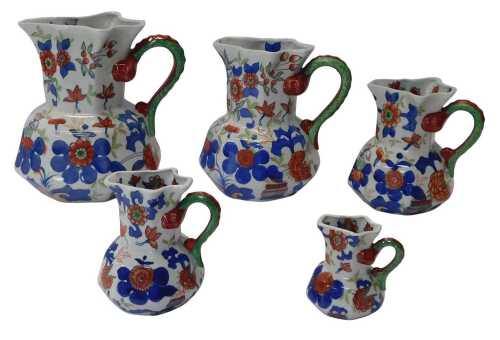 A graduated set of five ironstone hydra jugs, each decorated with flowers, the largest 25cm high.