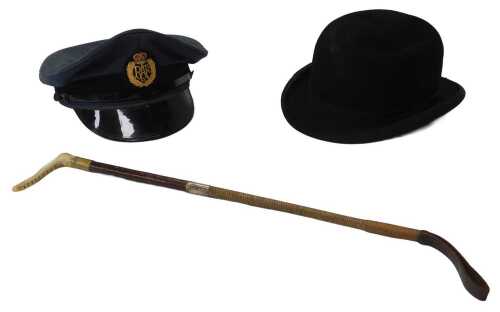 A Dunn and Co black felt bowler hat, together with an RAF dress peaked cap, and a riding crop. (3)