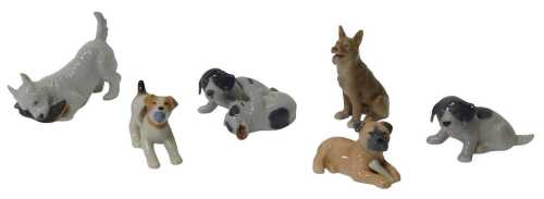 A group of Royal Copenhagen porcelain dogs, to include a West Highland Terrier chewing a slipper,...