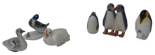 Four Royal Copenhagen porcelain birds, to include a figure group of two penguins, 10cm high,...
