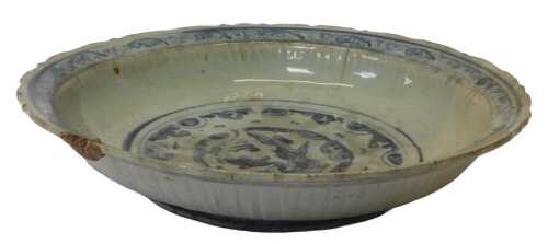 A Ming dynasty Chinese blue and white porcelain bowl, of semi-fluted form, painted centrally...