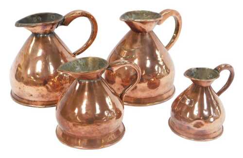 A group of Victorian copper jugs, comprising two half-gallon, a quart jug, and a one-pint jug.