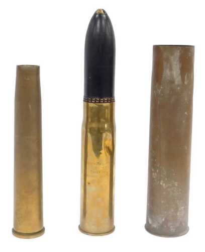 Three brass shell cases, one for 75 DEC MGM 457L 18BX, 35cm high.