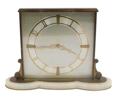 An Art Deco brass and onyx mantel clock, the silvered square dial bearing Arabic numerals and...
