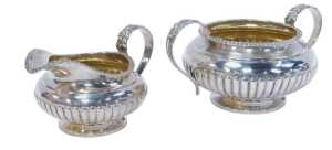 A William IV silver twin-handled sugar bowl and cream jug, each with a gadrooned rim and...