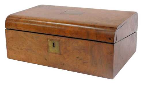 A Victorian walnut writing box, the domed lid inset with a brass cartouche, opening to reveal a...