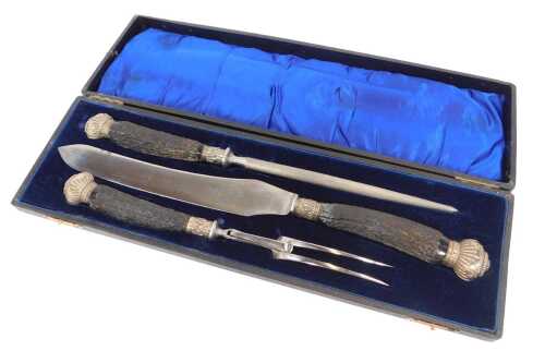 A simulated horn handled three-piece carving set, the knife with a Wood & Co Birmingham blade,...