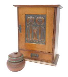 A late 19thC Art Nouveau oak smoker's cabinet, the top with a moulded edge, above a panelled...