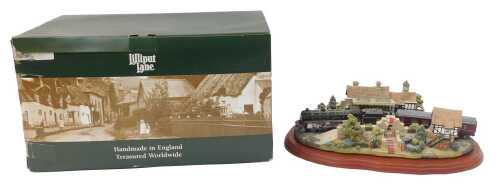 A Lilliput Lane group titled The Royal Train at Sandringham, mounted on an oak base, boxed, 33cm...