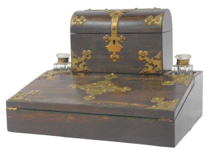 A Victorian coromandel and brass bound desk stand, the top surmounted by a domed stationery box,...