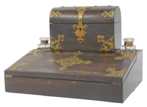 A Victorian coromandel and brass bound desk stand, the top surmounted by a domed stationery box,...