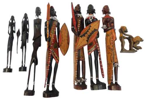 A group of carved hardwood tribal figures, including some painted examples, with beadwork...