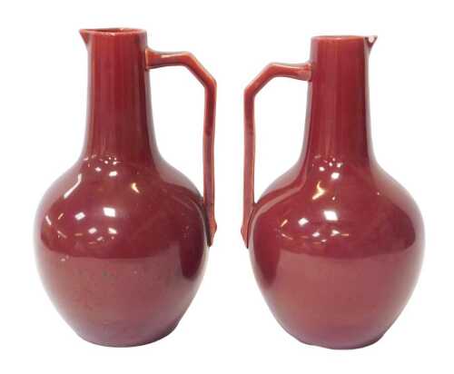 A pair of Christopher Dresser for Samuel Lear pottery jugs, each of globular form with an...