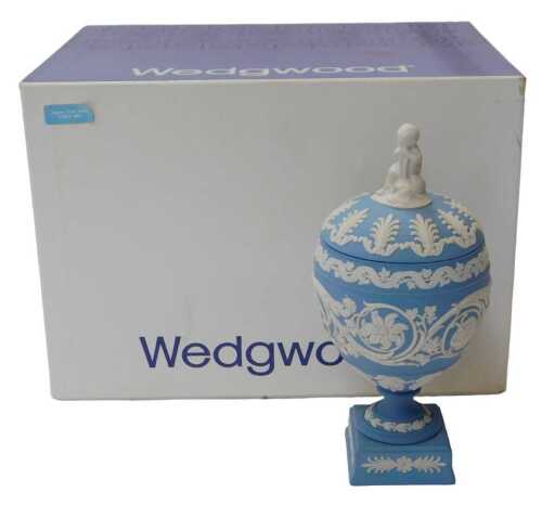 A Wedgwood blue Jasperware vase and cover, the lidded vase of globular form, with a cherub...