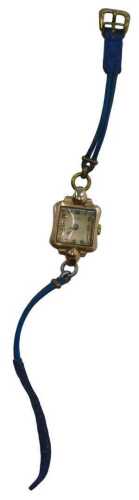 A 9ct gold Ancre lady's wristwatch, the square set dial, on a silvered back, with numbers and...