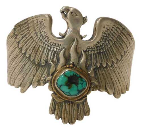 A contemporary silver eagle bangle, mounted with a turquoise, London, 12.5cm wide, 125.7g all in.