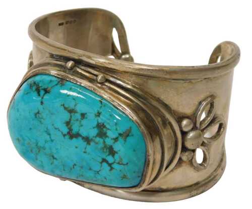 A 20thC silver bangle, with a rough-cut turquoise in an oval setting, floral band, London 1987,...