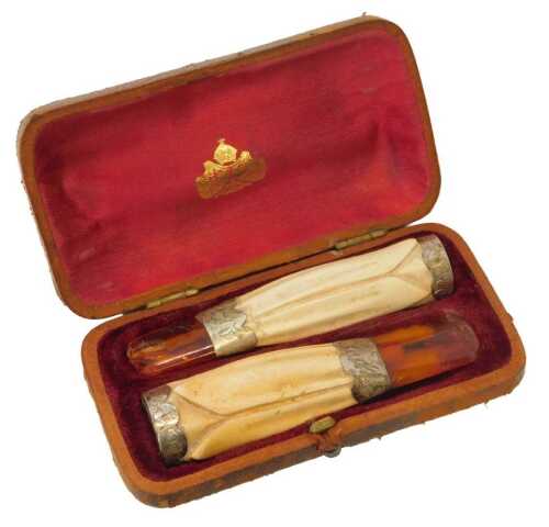 A pair of late 19thC meerschaum pipes, each with an amber cheroot holder, formed as a tulip,...