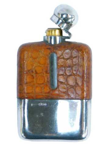 A George VI hip flask, with a silver lid, lacking a stopper, the glass bottle with a brown...
